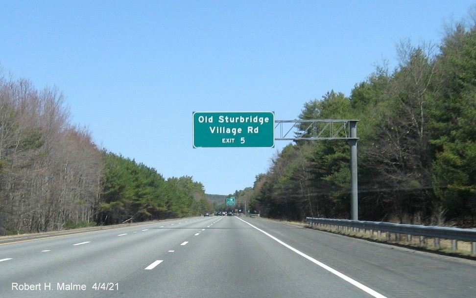 Image of overhead auxiliary sign for To MA 131 exit with new milepost based exit number on I-84 East in Sturbridge, April 2021