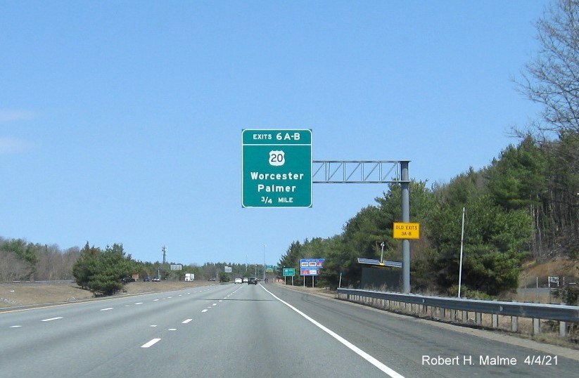 Image of 3/4 Mile advance overhead sign for US 20 exits with new milepost based exit numbers and yellow Old Exits 3 A-B advisory sign on right support on I-84 East in Sturbridge, April 2021