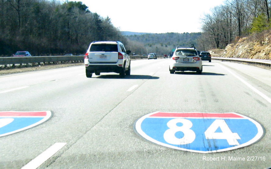 Image of painted I-84 and (partial) I-90 shields on pavement prior to I-84 exit in Strubridge