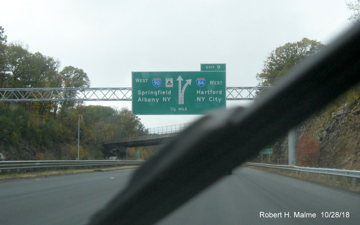 Image of newly placed 1/2 mile advance overhead diagrammatic sign for I-84 exit on I-90/Mass Pike West in Sturbridge, closeup version