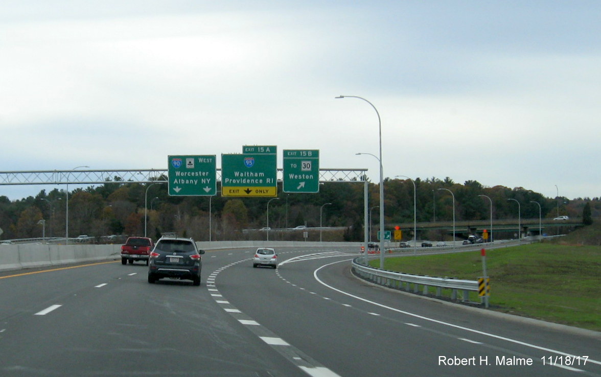 Image of ramp signage and grass growing in old Weston Toll Plaza area I-95 ramp from I-90 West