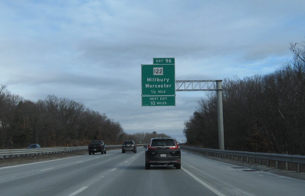 Image of 1/2 mile advance sign for MA 122 exit with new milepost based exit number and Next Exit 10 miles tab below on I-90/Mass Pike East in Millbury, January 2021