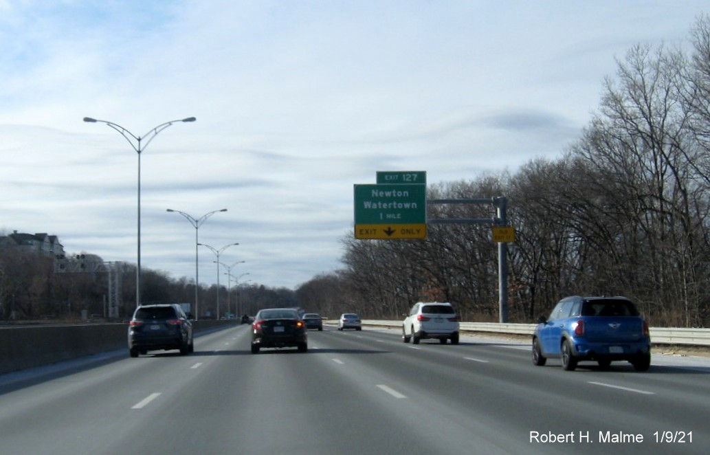 Image of 1-mile advance sign for Newton/Watertown exit with new milepost based exit number and yellow Old Exit 17 sign on support post on I-90/Mass Pike West in Newton, January 2021