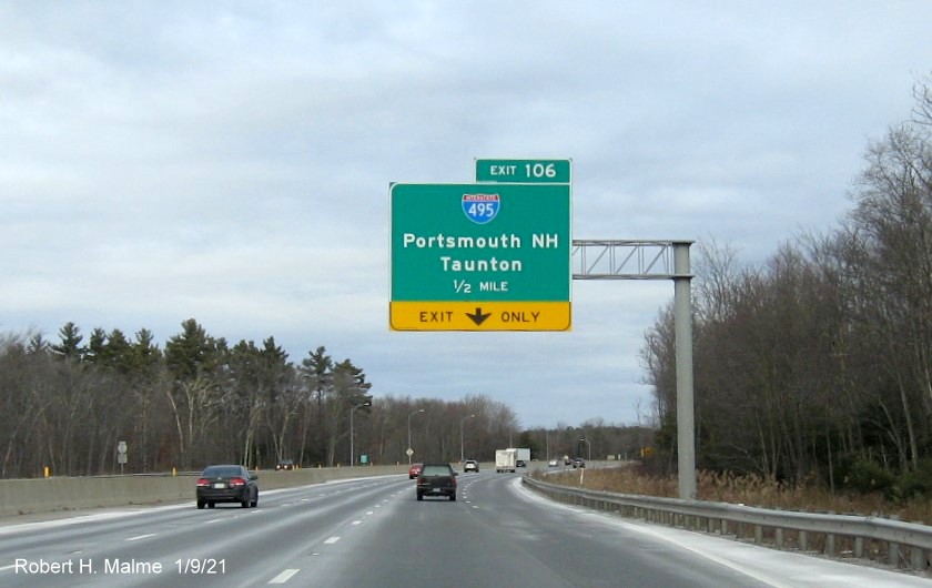 Image of 1/2 mile advance overhead sign for I-495 exit with new milepost based exit number on I-90/Mass Pike East in Hopkinton, January 2021