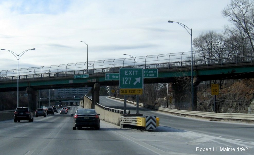 Image of gore sign for Newton/Watertown exit with new milepost based exit number and yellow Old Exit 17 sign below on I-90/Mass Pike West in Newton, January 2021