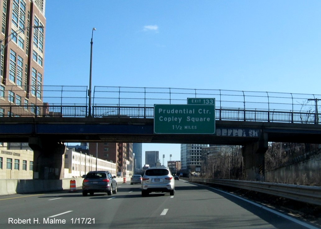 Image of 1 1/2 Miles advance bridge mounted sign for Prudential Center exit with new milepost based exit number on I-90/Massachusetts Turnpike East in Boston, January 2021