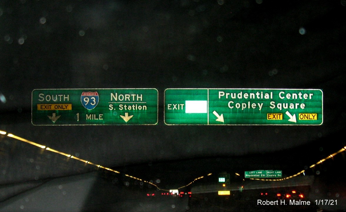 Image of overhead signs in Prudential Center tunnel with new milepost based exit number on I-90/Massachusetts Turnpike East in Boston, January 2021