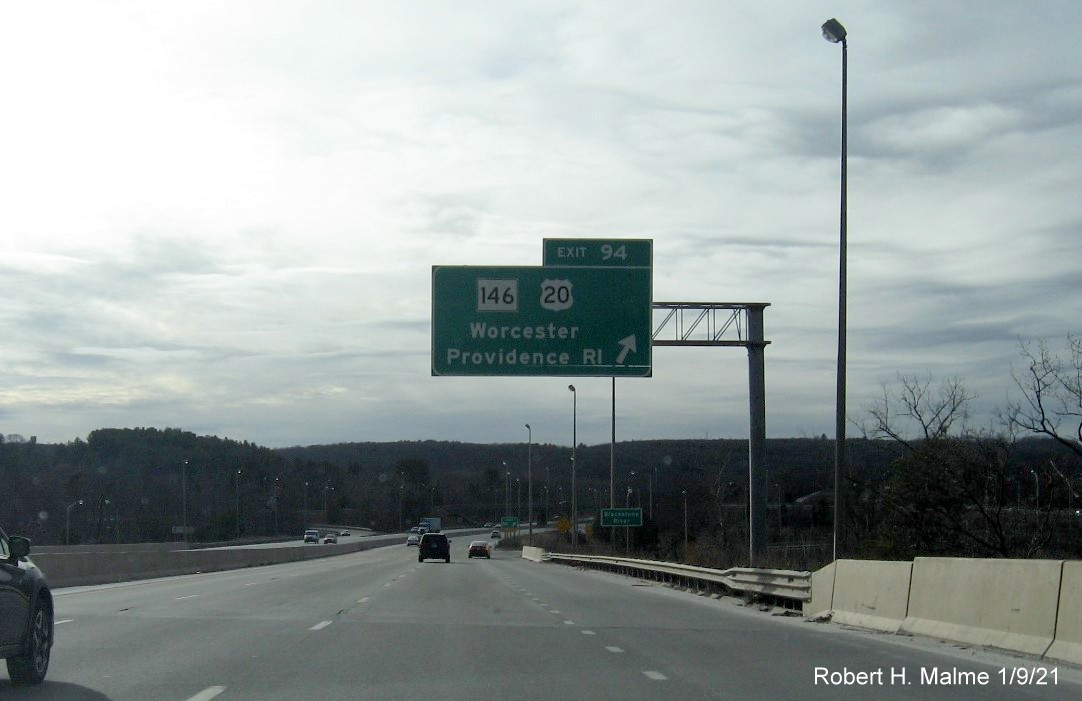 Image of overhead ramp sign for US 20/MA 146 exit with new milepost based exit number on I-90/Mass Pike West in Worcester, January 2021