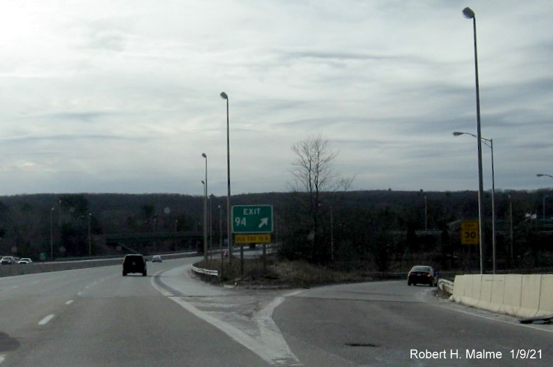 Image of gore sign for US 20/MA 146 exit with new milepost based exit number and yellow old exit sign below on I-90/Mass Pike West in Worcester, January 2021