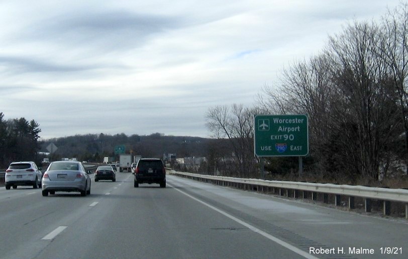 Image of auxiliary sign for Worcester Airport for I-290/I-395/MA 12 exit with new milepost based exit number on I-90/Mass Pike West in Auburn, by Vinh Lam, December 2020