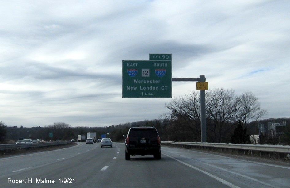Image of 1-mile advance overhead sign for I-290/I-395/MA 12 exit with new milepost based exit number and yellow Old Exit 10 sign on support post on I-90/Mass Pike West in Auburn, by Vinh Lam, December 2020