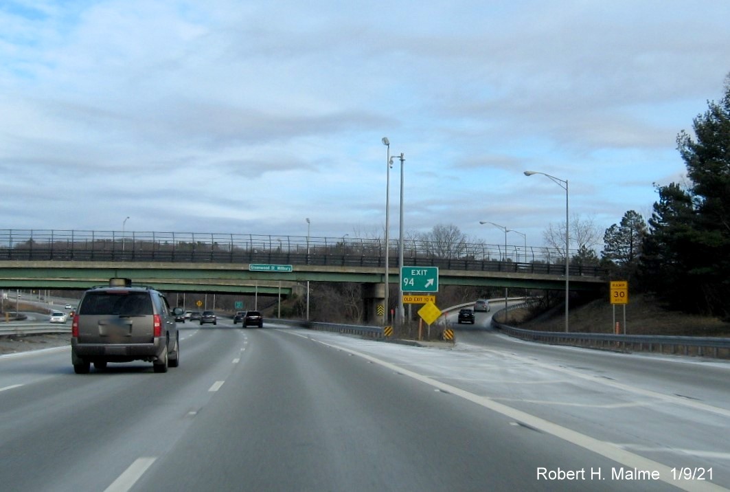 Image of gore sign for US 20/MA 146 exit with new milepost based exit number and yellow old exit sign below on I-90/Mass Pike East in Worcester, January 2021