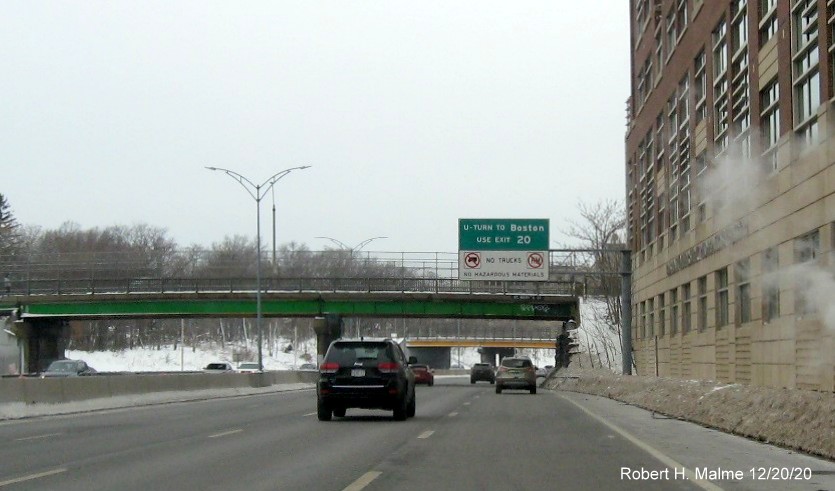 Image of overhead sign for U-Turn with existing exit number on I-90 West in Boston, December 2020