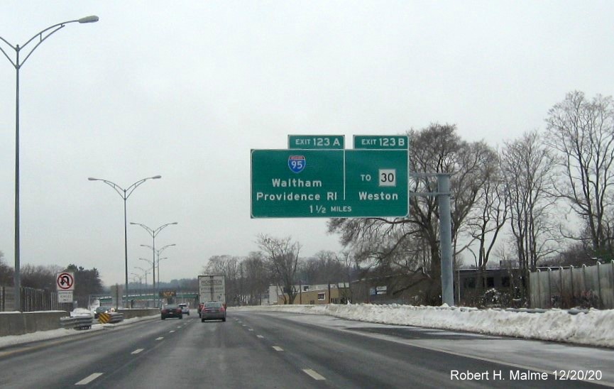 Image of 1 1/2 mile advance overhead sign for I-95/To MA 30 exits with new milepost based numbers on I-90/Mass Pike West in Newton, December 2020