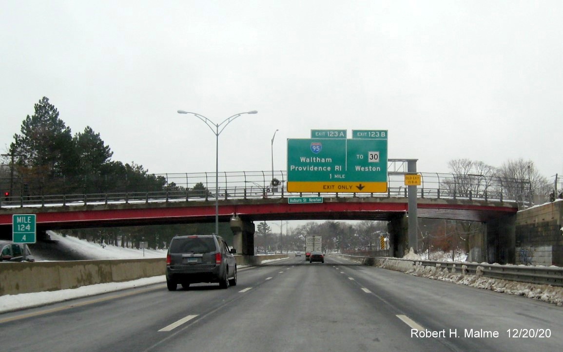 Image of 1-mile advance sign for I-95 and To MA 30 exits with new milepost based exit numbers and yellow old exit number sign on support on I-90/Mass Pike West in Newton
