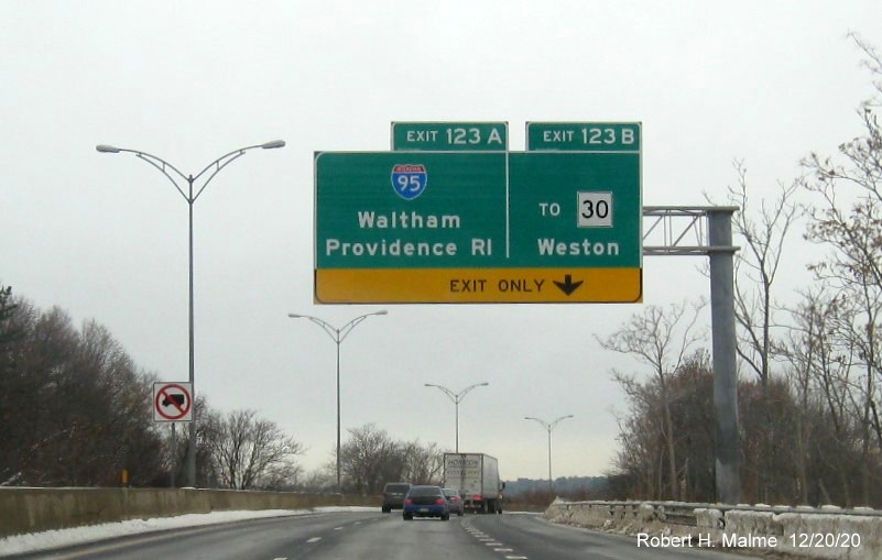 Image of 1/2 mile advance overhead sign for I-95 and To MA 30 exits with new milepost based exit number on I-90/Mass Pike West in Weston, December 2020