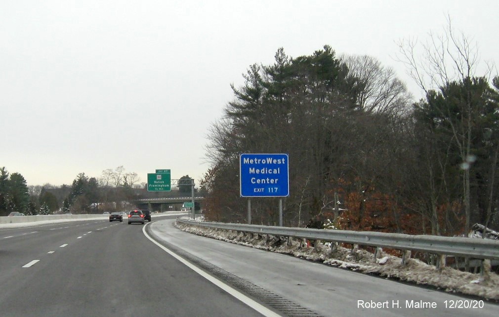 Image of auxiliary sign for MA 30 exit with new milepost based exit number on I-90/Mass Pike West in Natick, December 2020