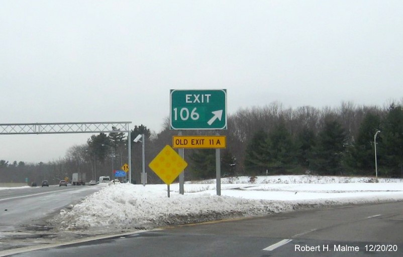 Image of gore sign for I-495 exit with new milepost based exit number and yellow old exit number tab underneath on I-90/Mass Pike West in Southboro, December 2020