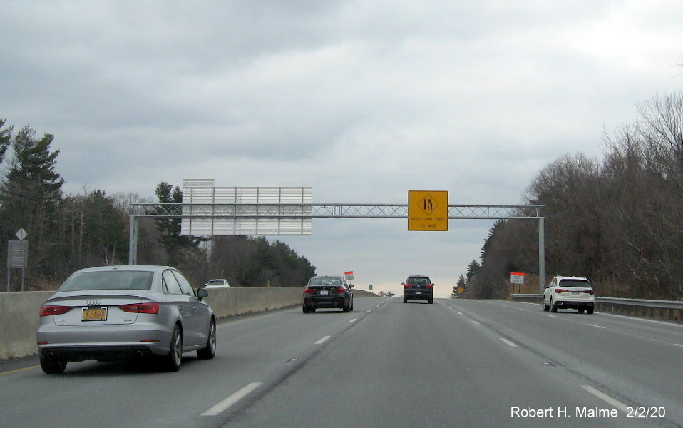 Image of overhead Right Lane Ends 1/2 Mile advisory sign on back of gantry for I-95 1-Mile Advance sign eastbound on I-90/Mass Pike West in Weston