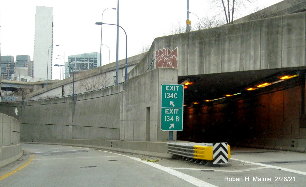 Image of gore signs for I-93 and South Boston exits with new milepost based exit numbers on I-90 
                                         East in Boston, February 2021