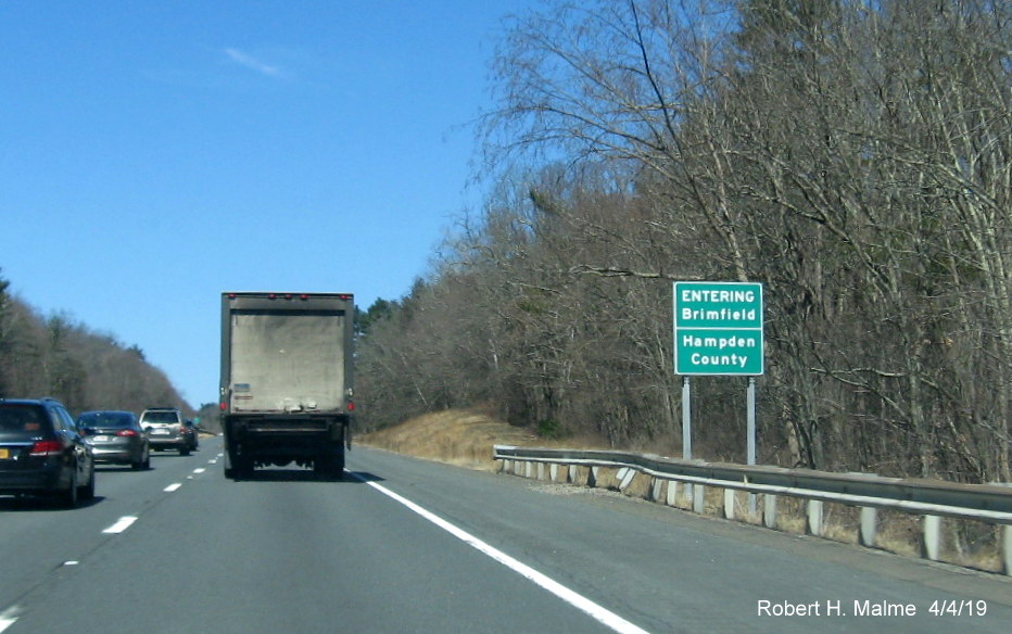 Image of recently place combination town line and county line sign on I-90/Mass Pike West entering Brimfield/Hampden County