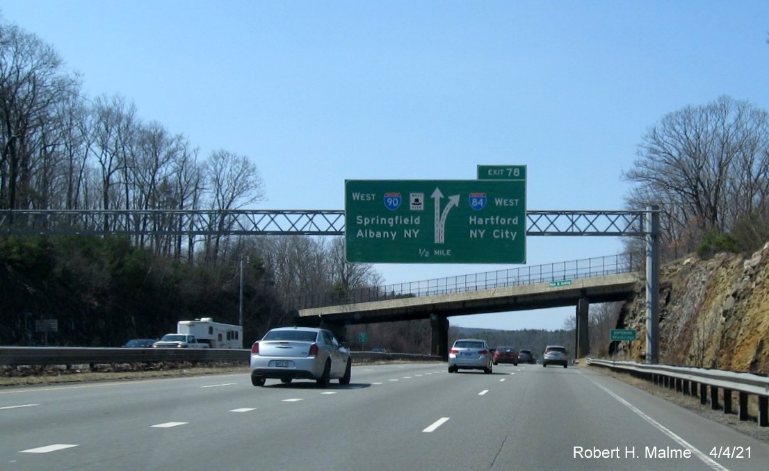 Image of 1/2 mile advance diagrammatic sign for I-84 exit with new milepost based exit number on I-90/Mass Pike West in Charlton, April 2021