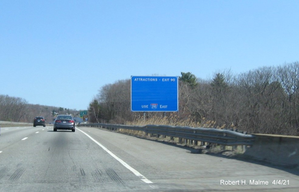 Image of blue Attractions services sign for I-290/I-395/MA 12 exit with new milepost based exit number 
                                             on I-90/Mass Pike East in Auburn, April 2021