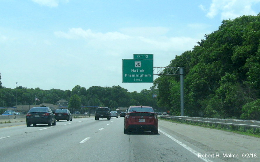Image of newly placed 1-mile advance overhead sign for MA 30 exit on I-90/Mass Pike West in Natick