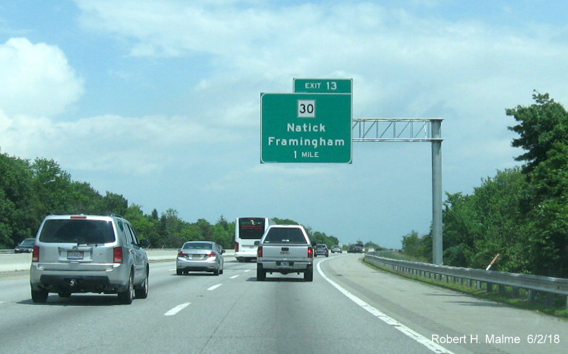 Image of newly placed 1-mile advance overhead sign for MA 30 exit on I-90/Mass Pike East in Natick