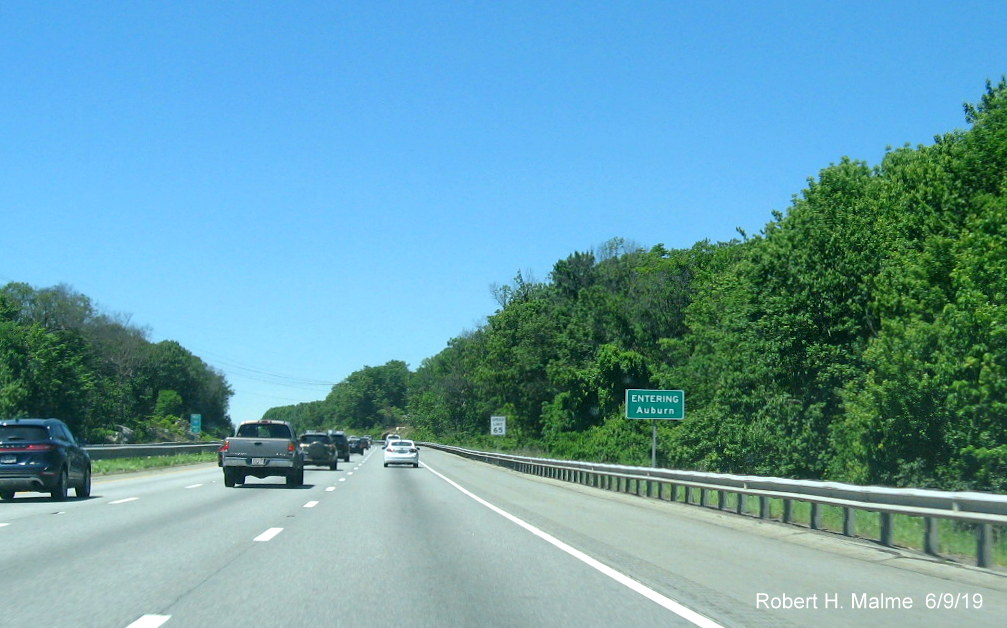 Image of recently placed ground mounted jurisdictional boundary sign for Auburn on I-90/Mass Pike West