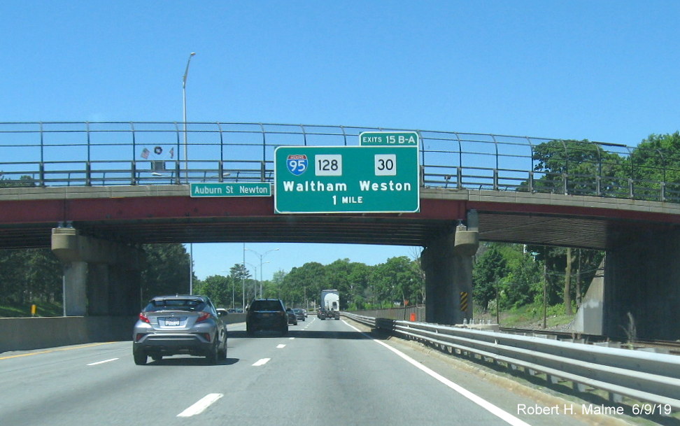 Image of orange contractor tag marking spot of future 1 mile advance overhead sign for I-95/To MA 30 exits on I-90 West in Newton