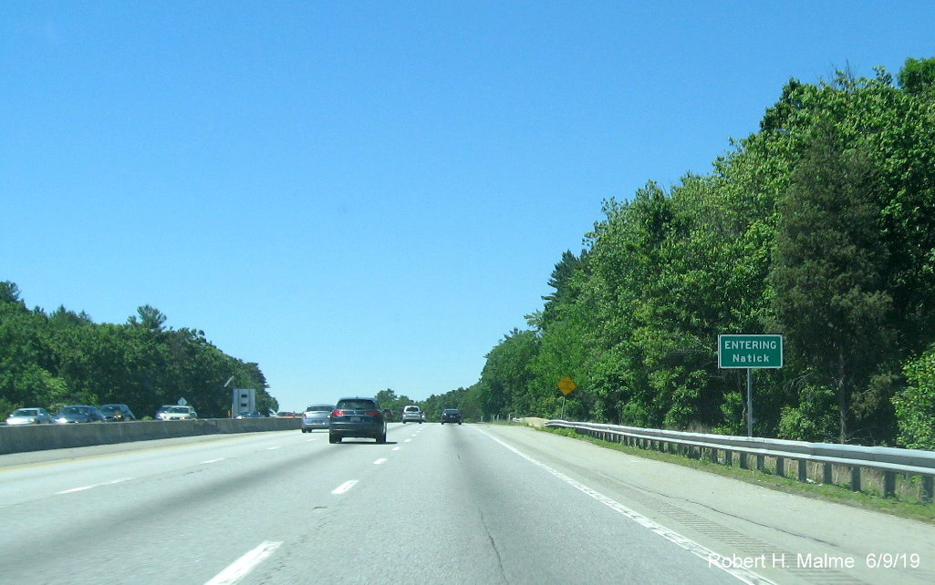 Image of recently placed Entering Natick ground mounted sign on I-90/Mass Pike East prior to MA 30 exit