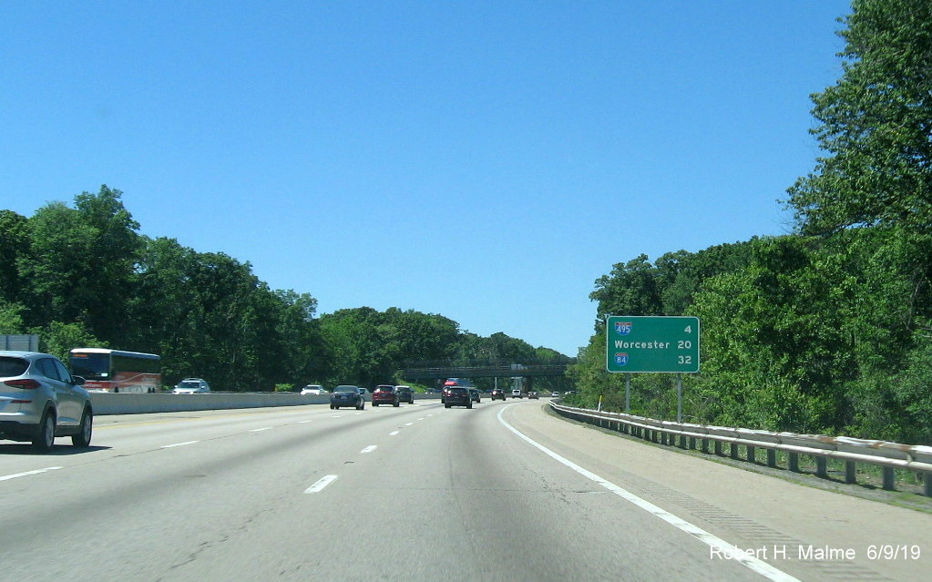 Image of recently placed ground mounted post-interchange distance sign with interstate shields on I-90/Mass Pike West after MA 9 exit in Framingham
