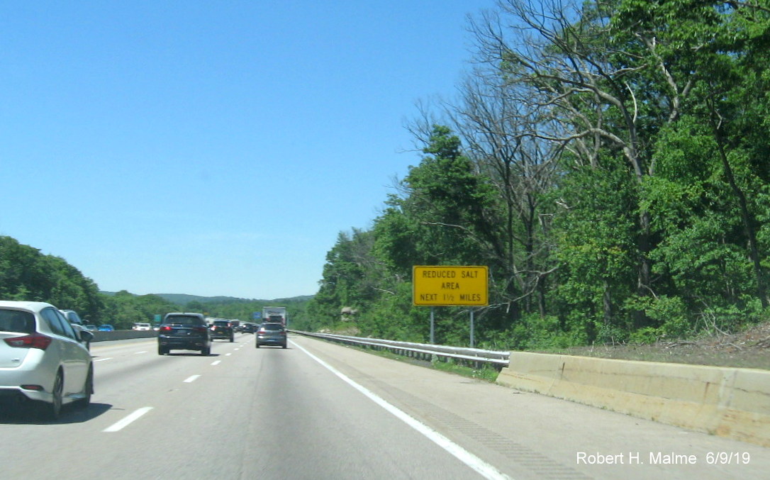 Image of ground mounted advisory sign for limited salt use on I-90/Mass Pike West in Westborough