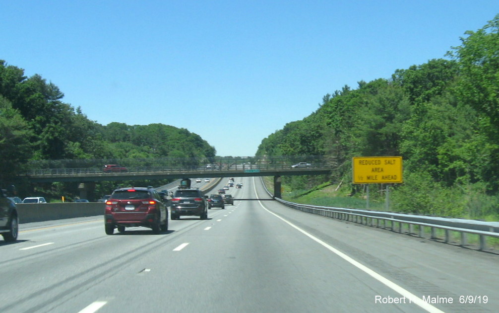 Image of recently installed yellow low salt use advisory sign on I-90/Mass Pike West in Westborough