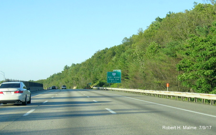 Image of contractor overhead sign support placement tag prior to I-495 exit sign on I-90/Mass Pike East in Westborough