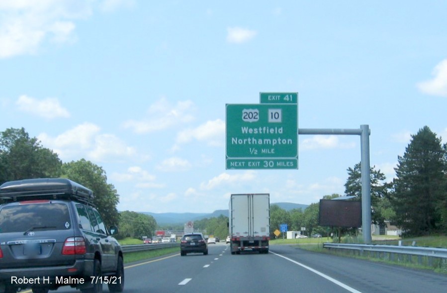 Image of 1/2 mile advance overhead sign for US 202/MA 10 exit with new milepost based exit number on I-90/Mass Pike West in Westfield, July 2021