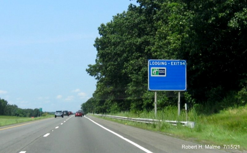 Image of blue Lodging services sign for MA 21 exit with new milepost based exit number on I-90/Mass Pike West in Ludlow, July 2021