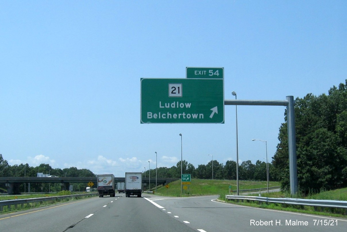 Image of overhead ramp sign for MA 21 exit with new milepost based exit number on I-90/Mass Pike West in Ludlow, July 2021
