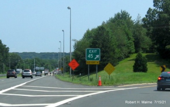 Image of gore sign for I-91/US 5 exit with new milepost based exit number and yellow Old Exit 4 sign attached below on I-90/Mass Pike East in West Springfield, July 2021