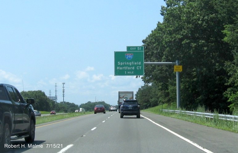 Image of 1 Mile advance overhead sign for I-291 exit with new milepost based exit number and yellow Old Exit 6 advisory sign on support on I-90/Mass Pike West in Chicopee, July 2021