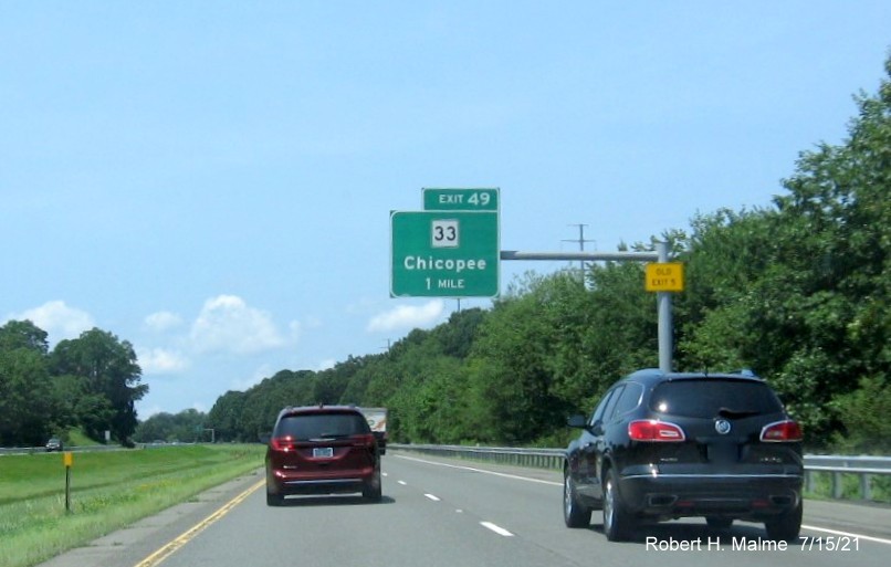 Image of 1 mile advance overhead sign for MA 33 exit with new milepost based exit number and yellow Old Exit 5 advisory sign on support on I-90/Mass Pike West in Chicopee, July 2021