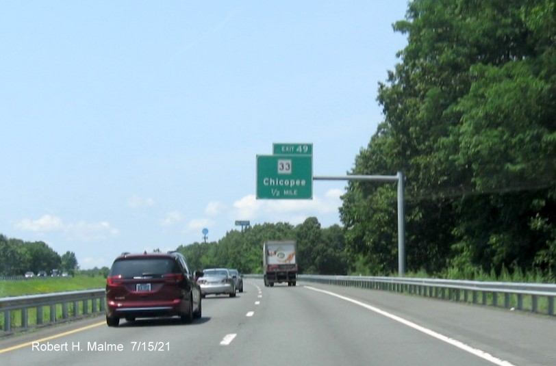 Image of 1/2 mile advance overhead sign for MA 33 exit with new milepost based exit number on I-90/Mass Pike West in Chicopee, July 2021