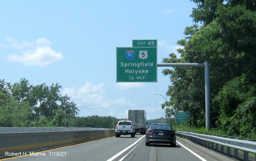 Image of 1/2 Mile advance overhead sign for I-91/US 5 exit with new milepost based exit number on I-90/Mass Pike West in Springfield, July 2021