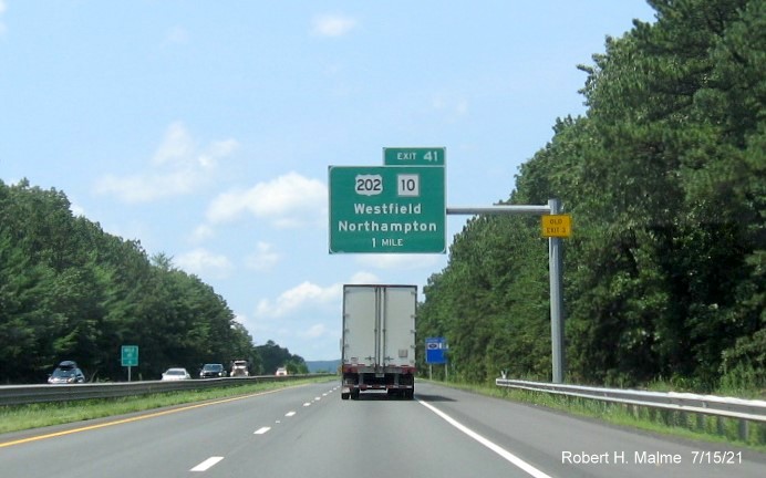 Image of 1 mile advance overhead sign for US 202/MA 10 exit with new milepost based exit number and yellow Old Exit 3 advisory sign on support on I-90/Mass Pike West in Westfield, July 2021