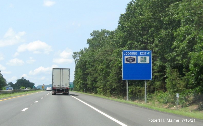 Image of blue Lodging services sign for US 202/MA 10 exit with new milepost based exit number on I-90/Mass Pike West in Westfield, July 2021