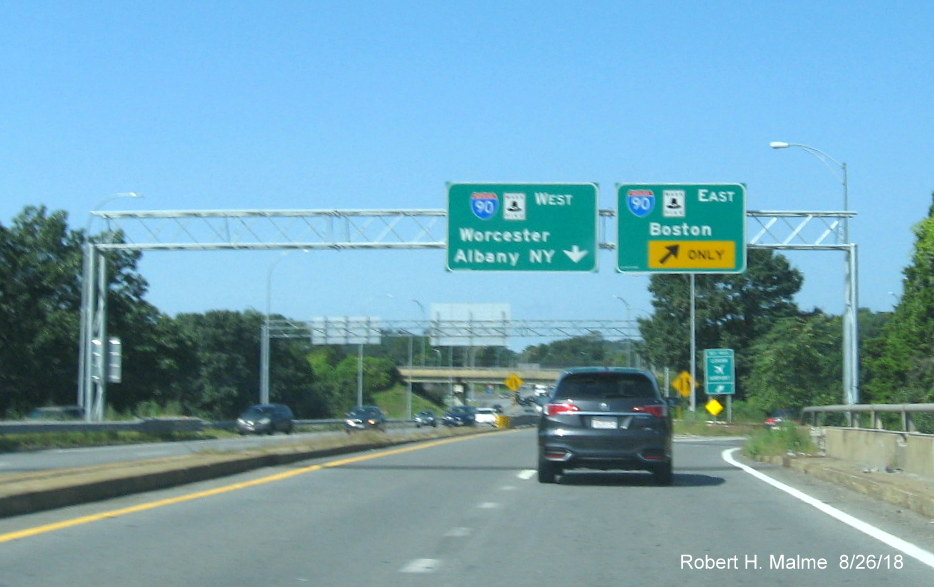 Image of new overhead guide signs for split of ramps for I-90/Mass Pike West and East for traffic from I-95 North in Weston