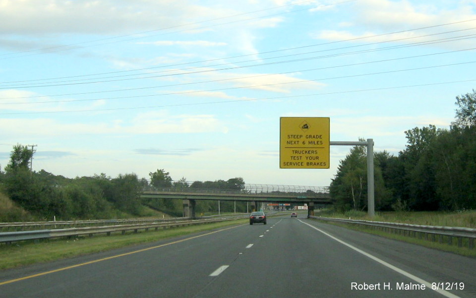 Image of recently placed overhead yellow truck downhill advisory sign on I-90/Mass Pike East 