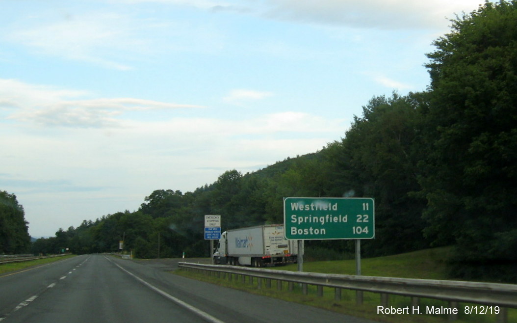 New version of distance sign placed halfway between Exits 2 and 3 on I-90/Mass Pike East