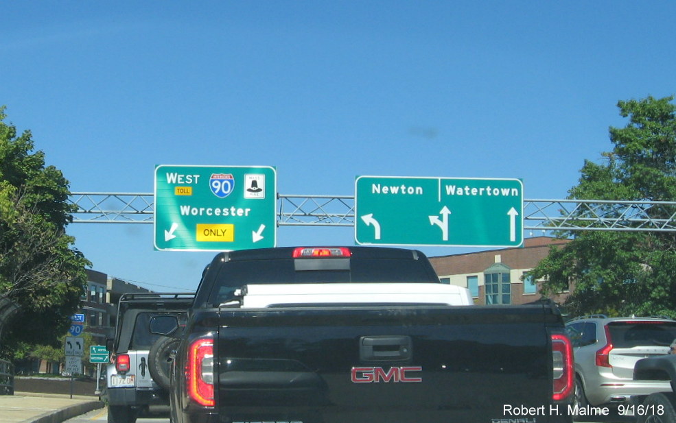 Image of recently placed overhead guide signs at on-ramp to I-90/Mass Pike West in Newton